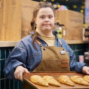 Confident Girl with Down Syndrome Working in Bakery